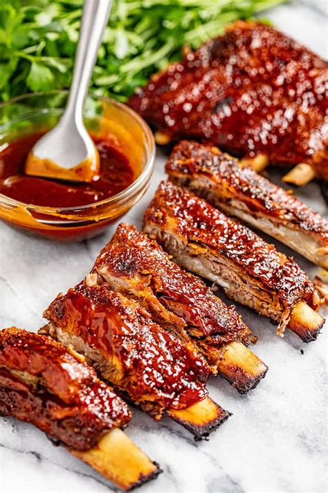 Preheat the oven to 100°C or 212°F for 20 minutes. Lay aluminum foil or waxed baking paper on a roasting pan or baking sheet. Place the marinated beef short ribs and splash some marinade but discard most of the sauce. Cook the meat for 35 or 45 minutes in the oven. Take the meat out and carve.